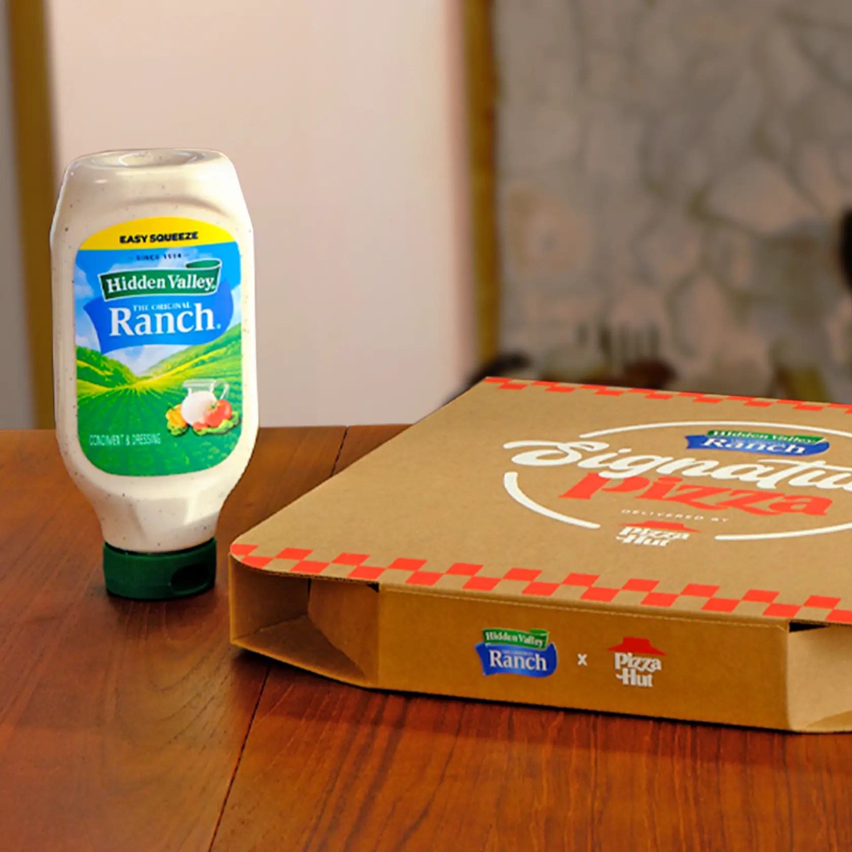 A Hidden Valley® Ranch Easy Squeeze bottle and a closed box of pizza